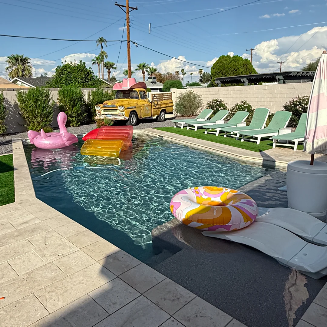 Mean Girls bachelorette pool setup with flamingo float and rainbow lounger in Scottsdale backyard